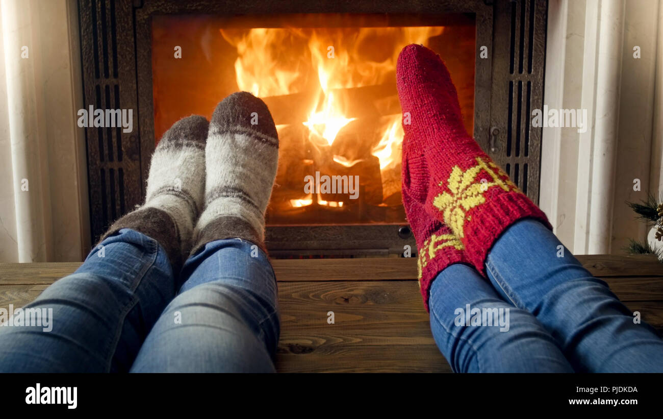 Closeup photo of family warming by the fireplace at cold night Stock ...