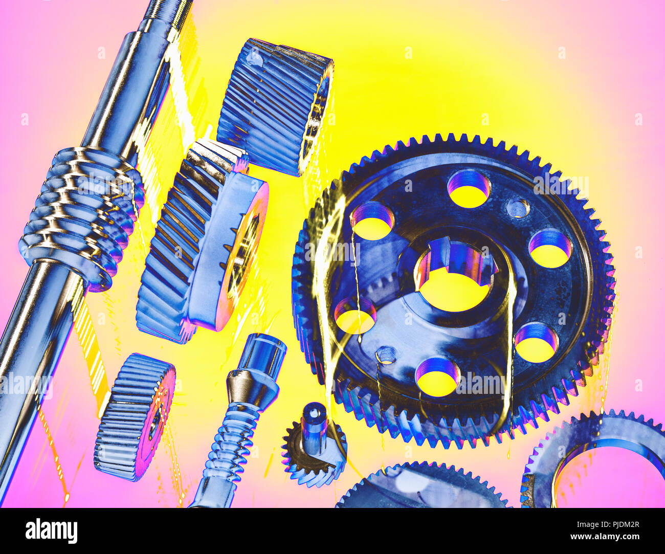 Solarised still life of precision engineered cogs and gears Stock Photo