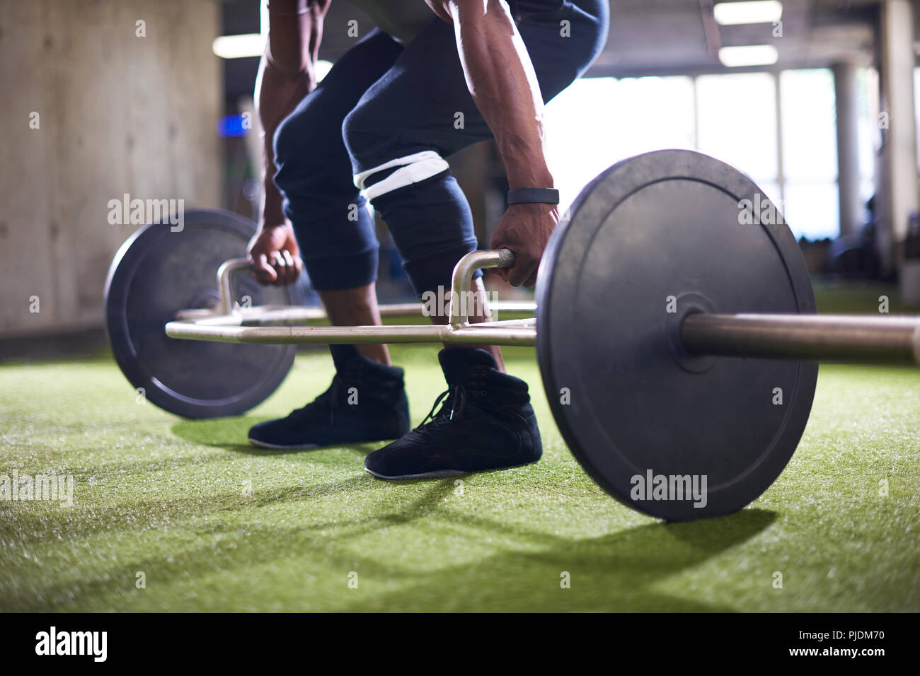Man lifting barbell in gym Stock Photo
