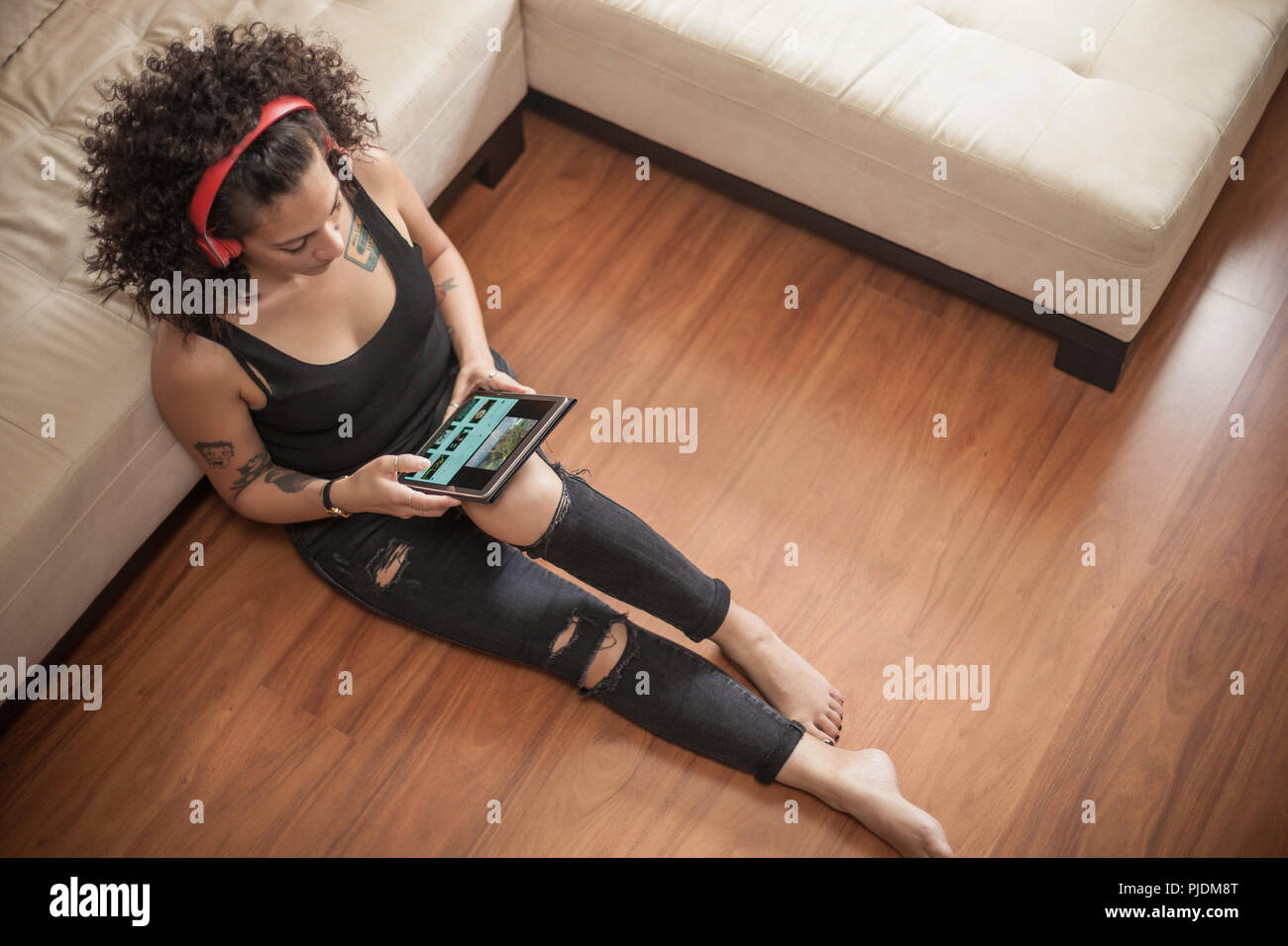 Woman listening to music on digital tablet at home Stock Photo