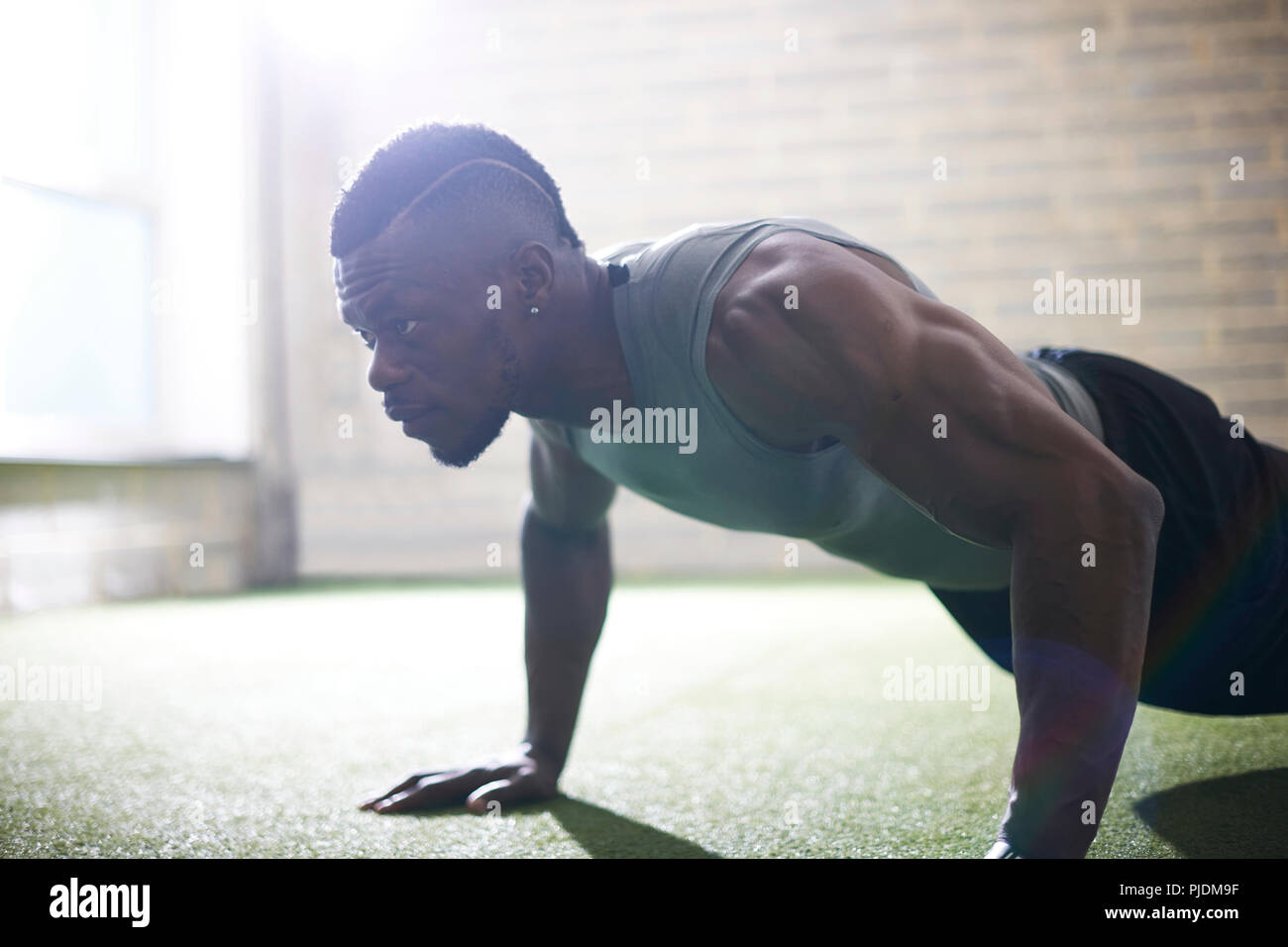 Man doing plank in gym Stock Photo