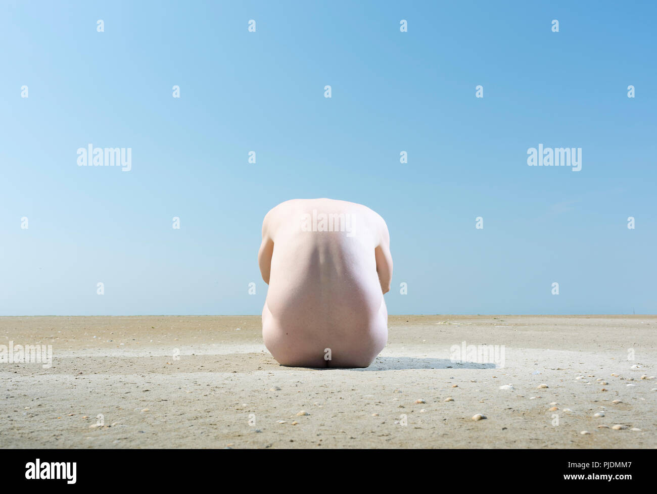 Nude man on sandbank Stock Photo