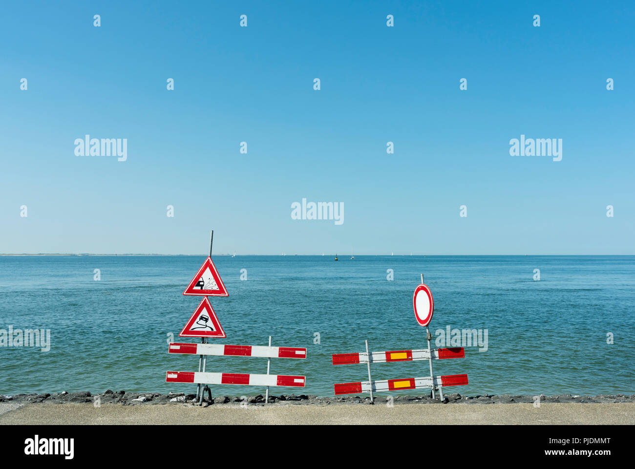 Traffic signs along shoreline Stock Photo