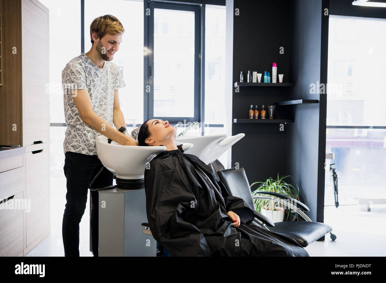 Beautiful young girl washing her head in a beauty salon Stock Photo