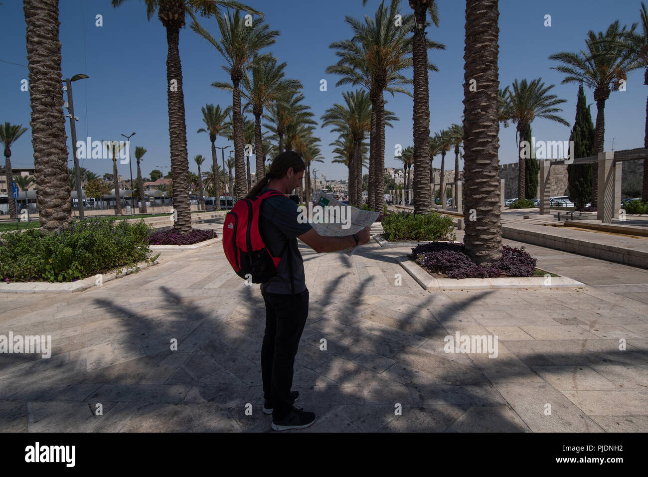 Young man looking at map on promenade in Jerusalem Stock Photo