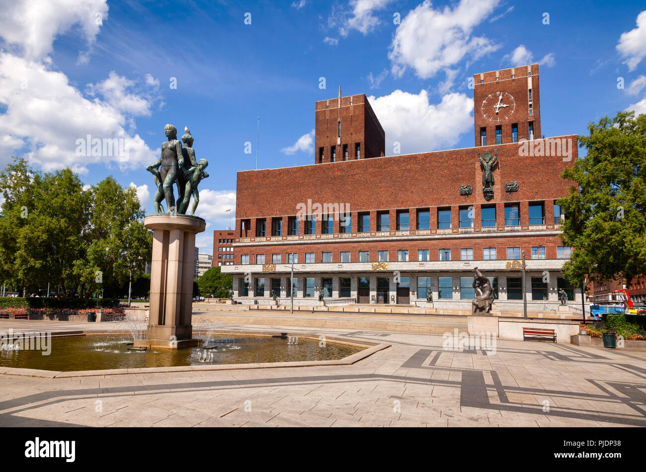 OSLO, NORWAY - JULY 12, 2018: The City Hall Square with sculptures  fountains and The City Hall (Radhus) in background Stock Photo