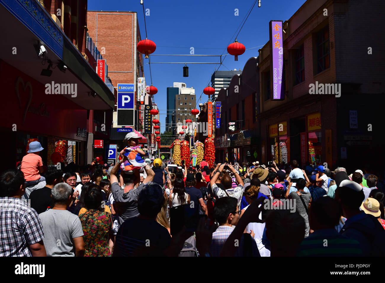 People celebrating Chinese New Year at Chinatown in Melbourne with dancing lions and dragon Stock Photo