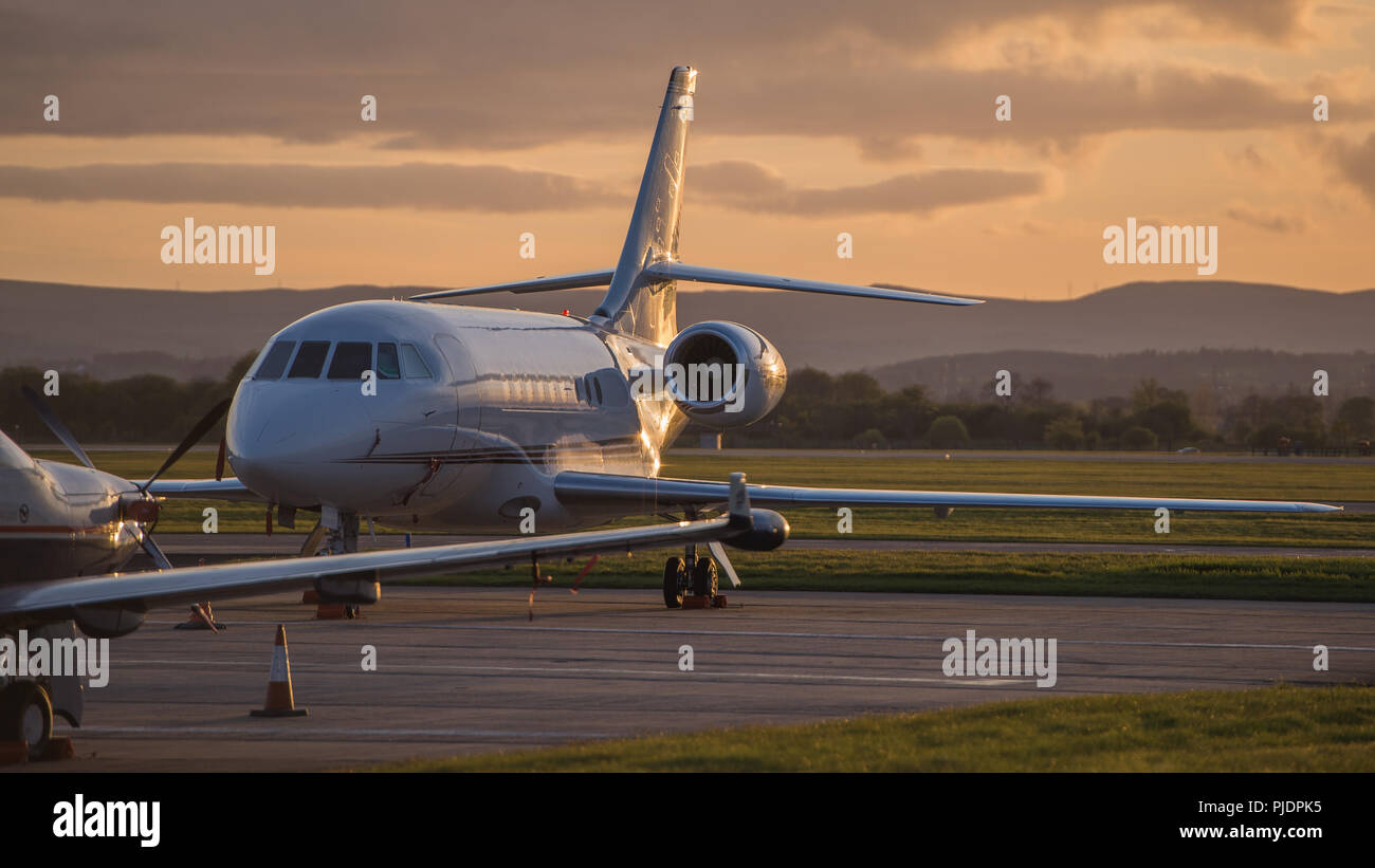 A Dassault Falcon business jet seen on the ramp at Glasgow International Airport, Renfrewshire, Scotland. Stock Photo