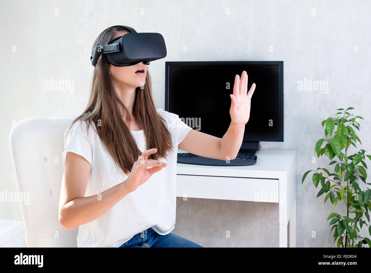 Smiling positive woman wearing virtual reality goggles headset, vr box ...