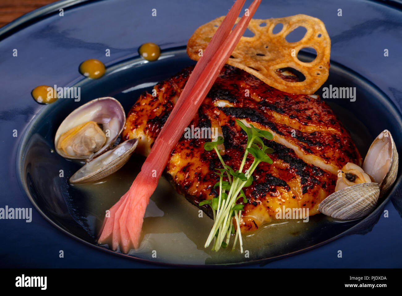 Roasted cod fish with scallops and sauce Stock Photo - Alamy