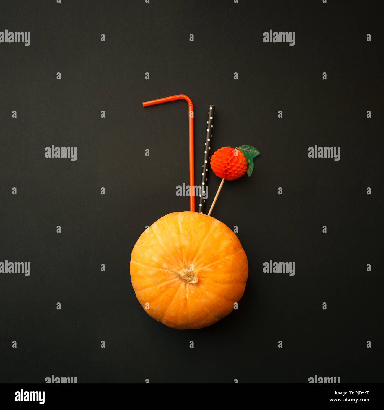 Concept of Halloween pumpkin orange cocktails on mystery black background. Festive drink, minimal trend Stock Photo