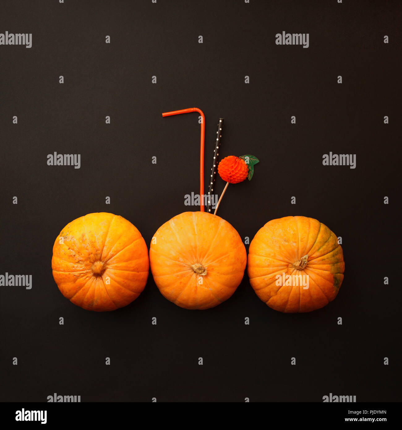 Concept of Halloween pumpkin orange cocktails on mystery black background. Festive drink, minimal trend Stock Photo