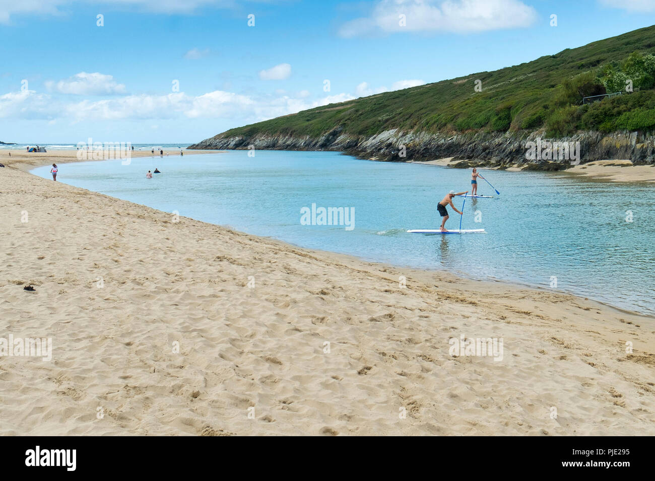 Holidaymakers on Stand up Paddleboards on the Gannel River at Crantock in Newquay Cornwall. Stock Photo
