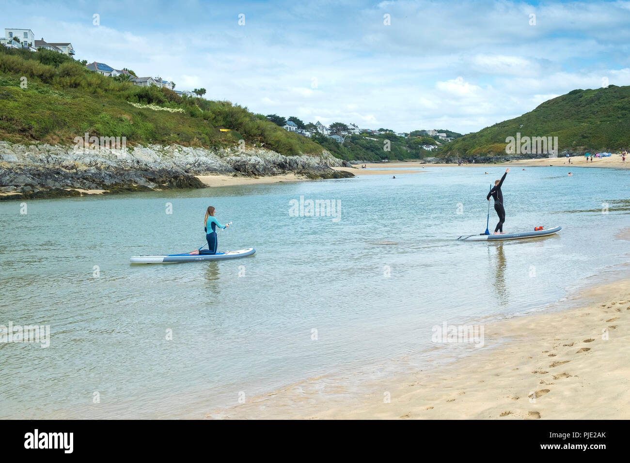 Holidaymakers on Stand up Paddleboards on the Gannel River at Crantock Beach in Newquay Cornwall. Stock Photo