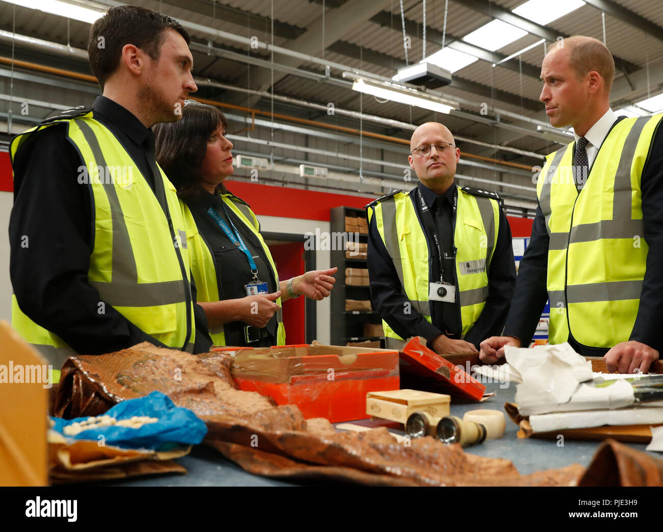 The Duke of Cambridge watches as a UK Border Force shows off various items found recently, including snake skin, ivory and plants that are not allowed into Britain at the Royal Mail's Worldwide International Logistics Centre, Heathrow, London, during his meeting with United for Wildlife to tackle illegal trafficking of wildlife products. Stock Photo