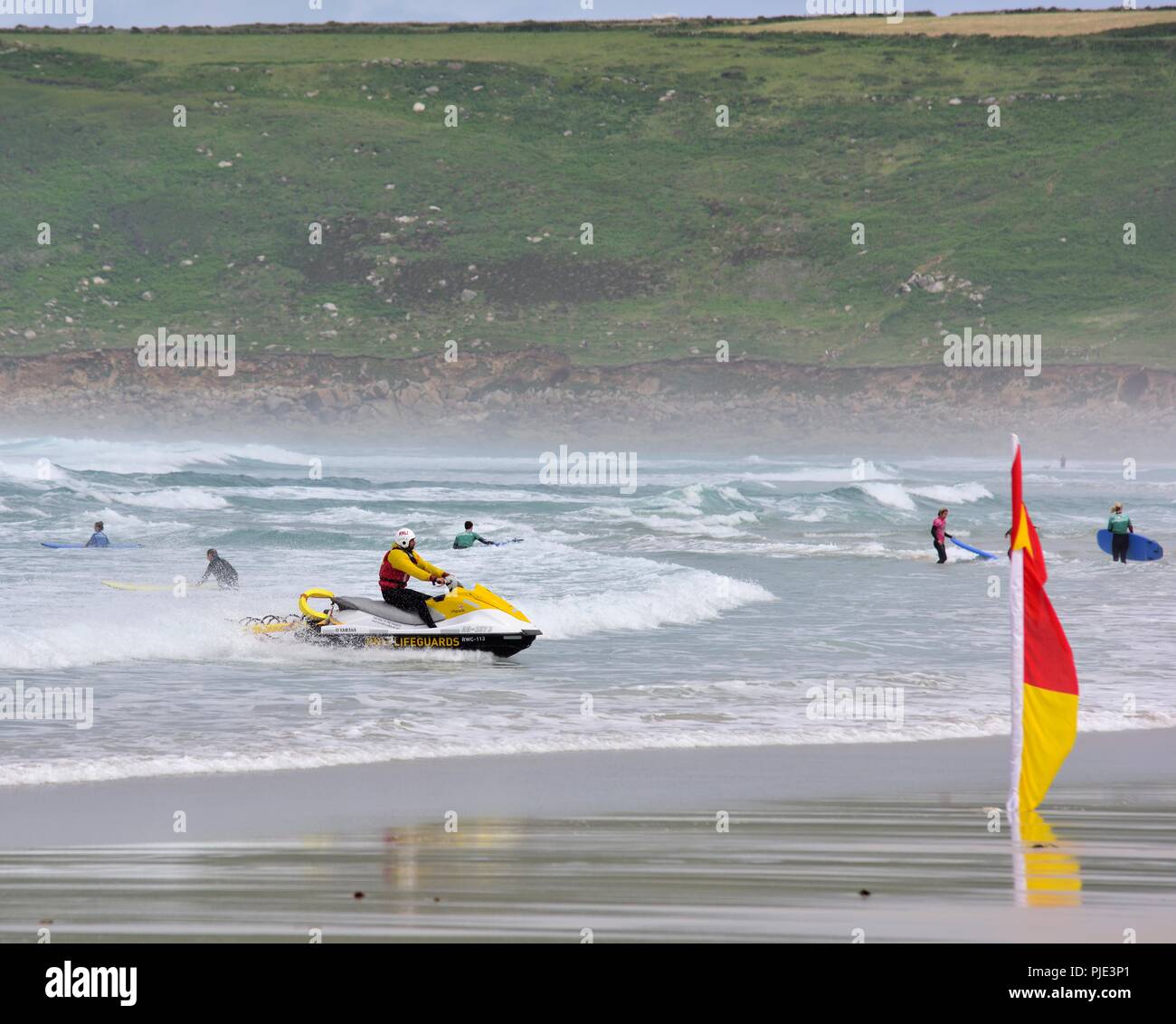 RNLI Lifeguard approaching the beach on rescue jet ski,Sennen Cove,Cornwall,England,UK Stock