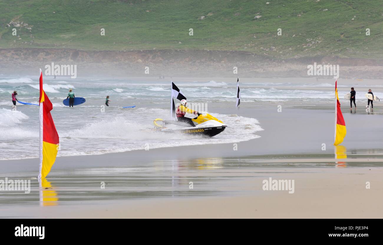 RNLI Lifeguard approaching the beach on rescue jet ski,Sennen Cove,Cornwall,England,UK Stock Photo