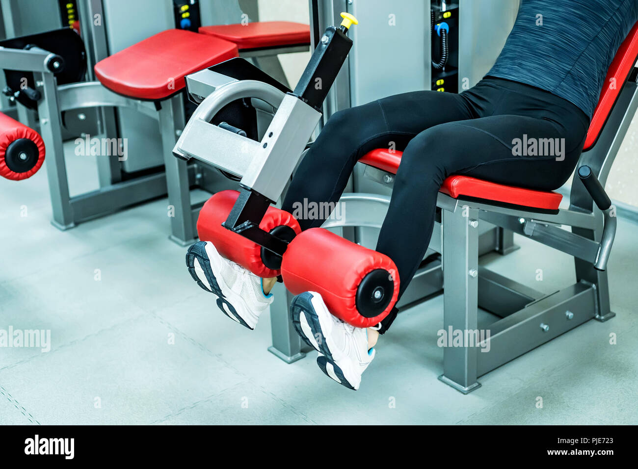 Young woman does leg exercises in gym Stock Photo Alamy