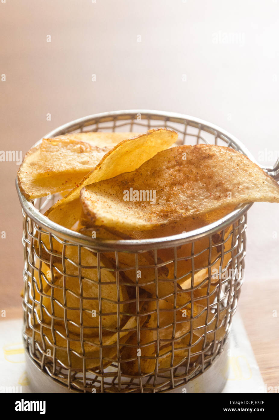 Potato chips served in a stainless steel fry basket Stock Photo Alamy