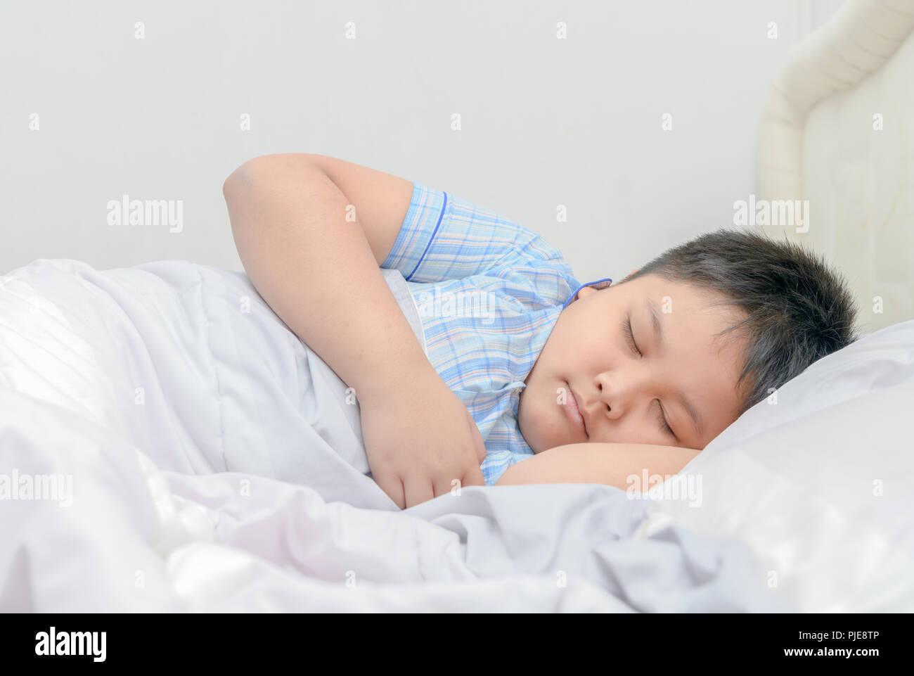 Obese fat boy sleeping on bed, relaxation concept Stock Photo Alamy