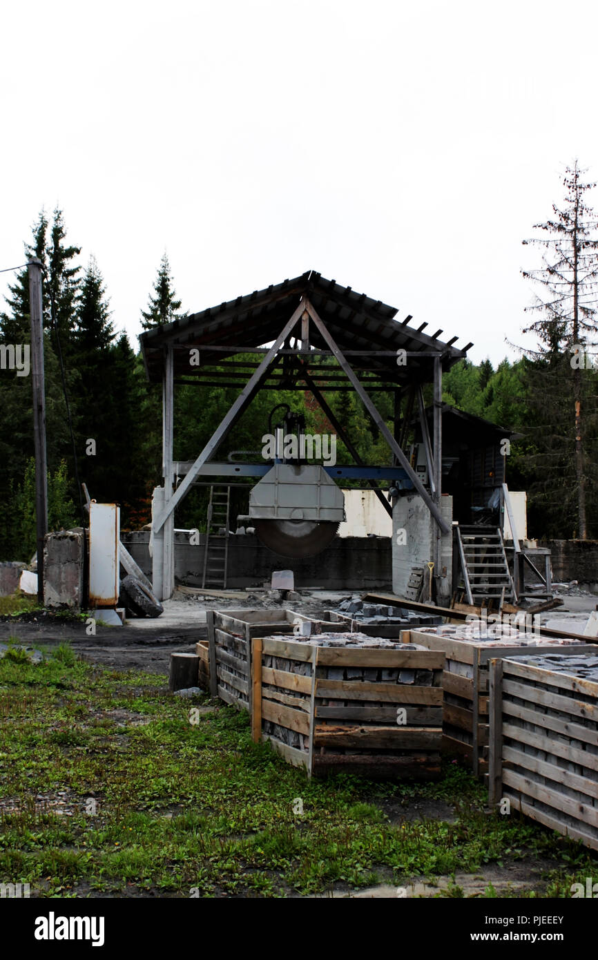 A large machine with a circular saw for cutting huge marble blanks and