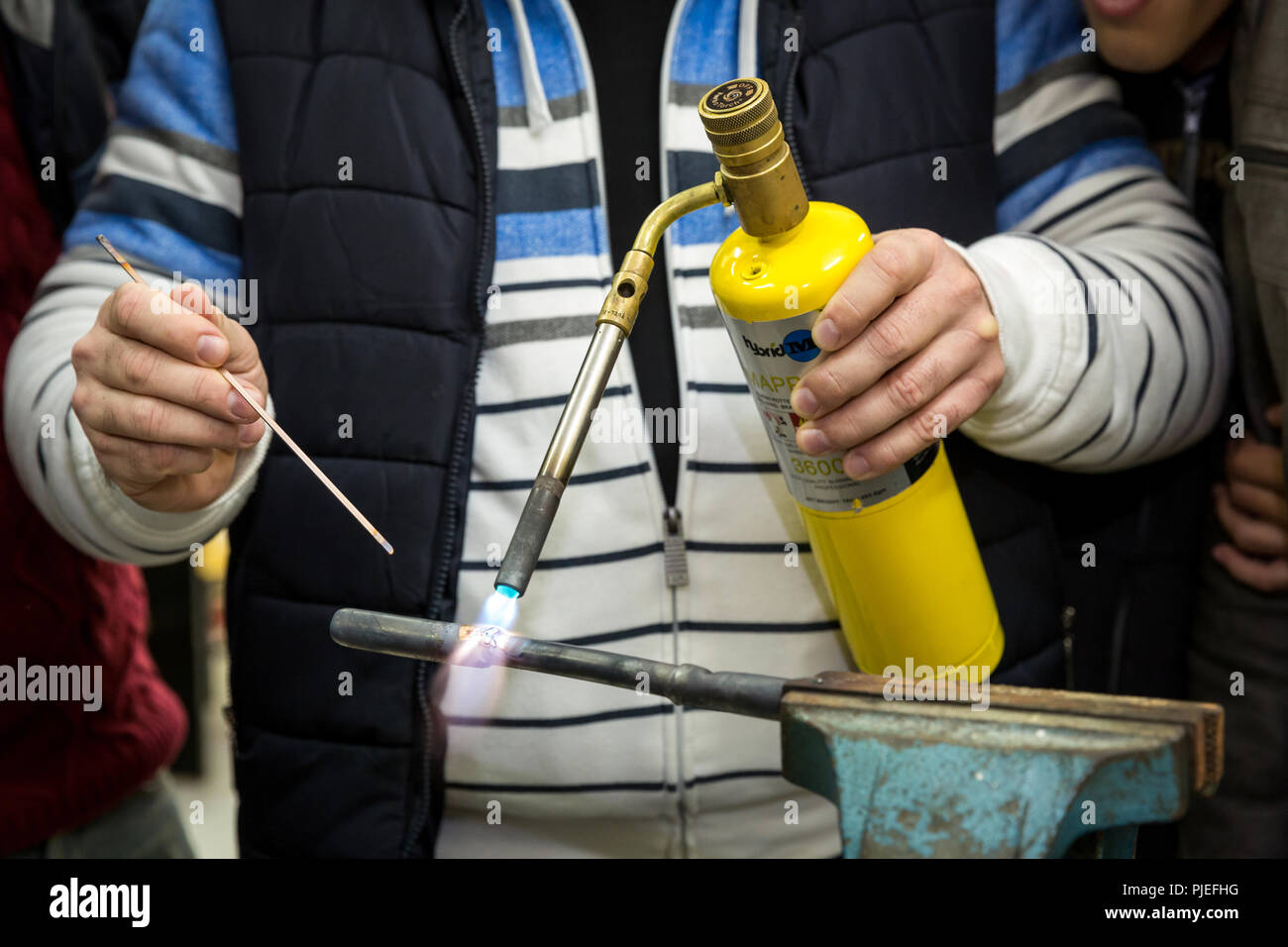 Young men are trained as plumbers in the plumbing workshop in the Devaid vocational training in the training center Public Professional Training 4 in Tirana Albania. Stock Photo