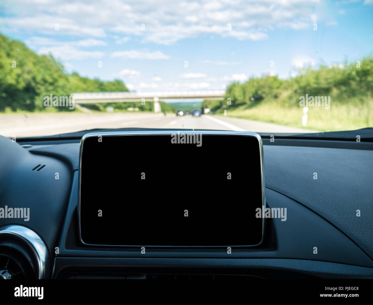 Car Interior with Navigation system and German Autobahn in background Stock Photo