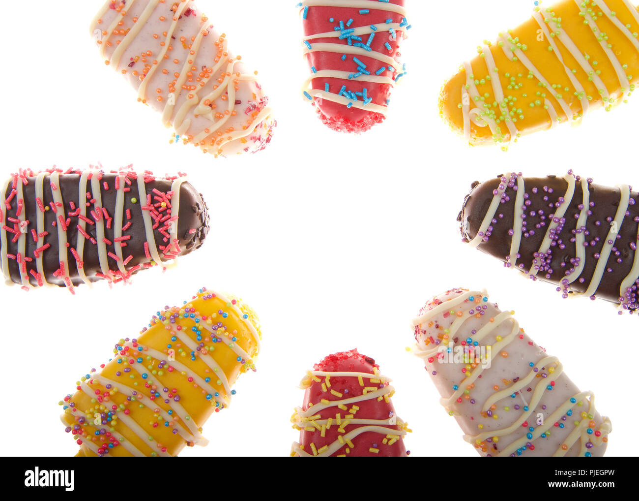 Close up on Multiple colored candy stripped popsicle cake pops with sprinkles on top isolated on white background.. Fun party food for kids Stock Photo