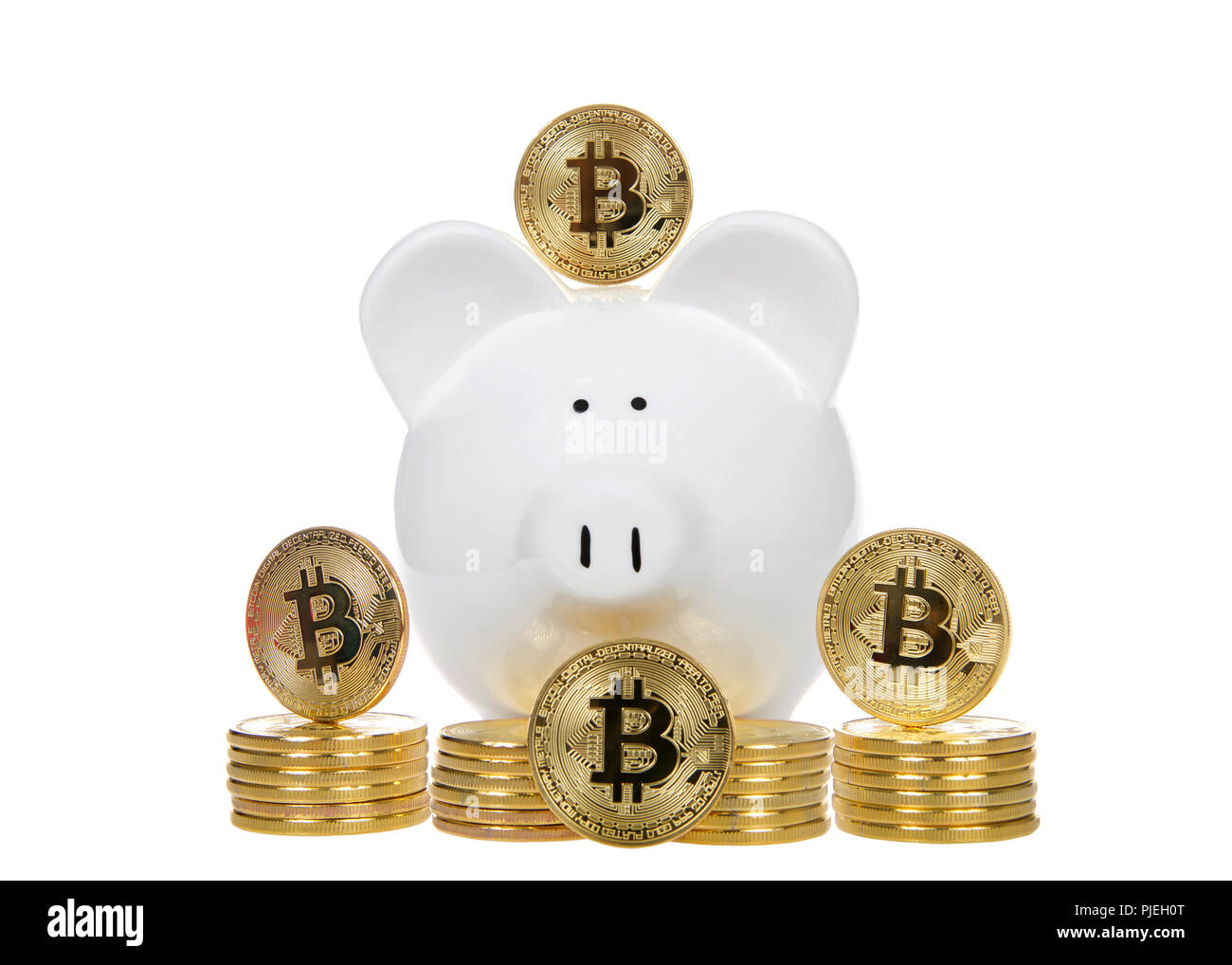 White piggy bank with bit coin physical coins stacked in front of it and  four up on end showing B for bitcoin design. Investing Stock Photo - Alamy
