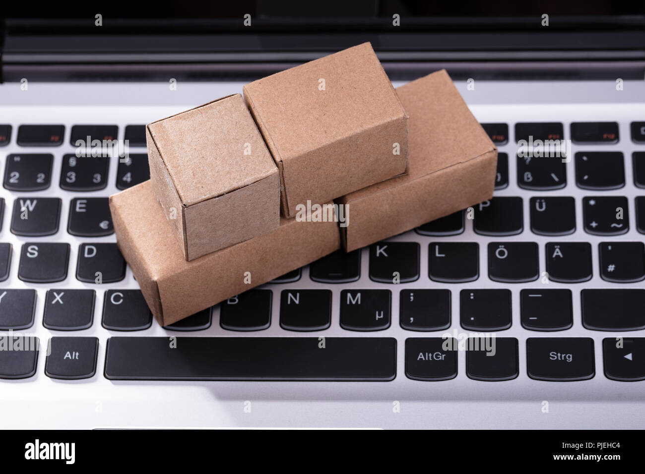 Close-up Of Small Cardboard Boxes On Laptop Keypad Stock Photo - Alamy