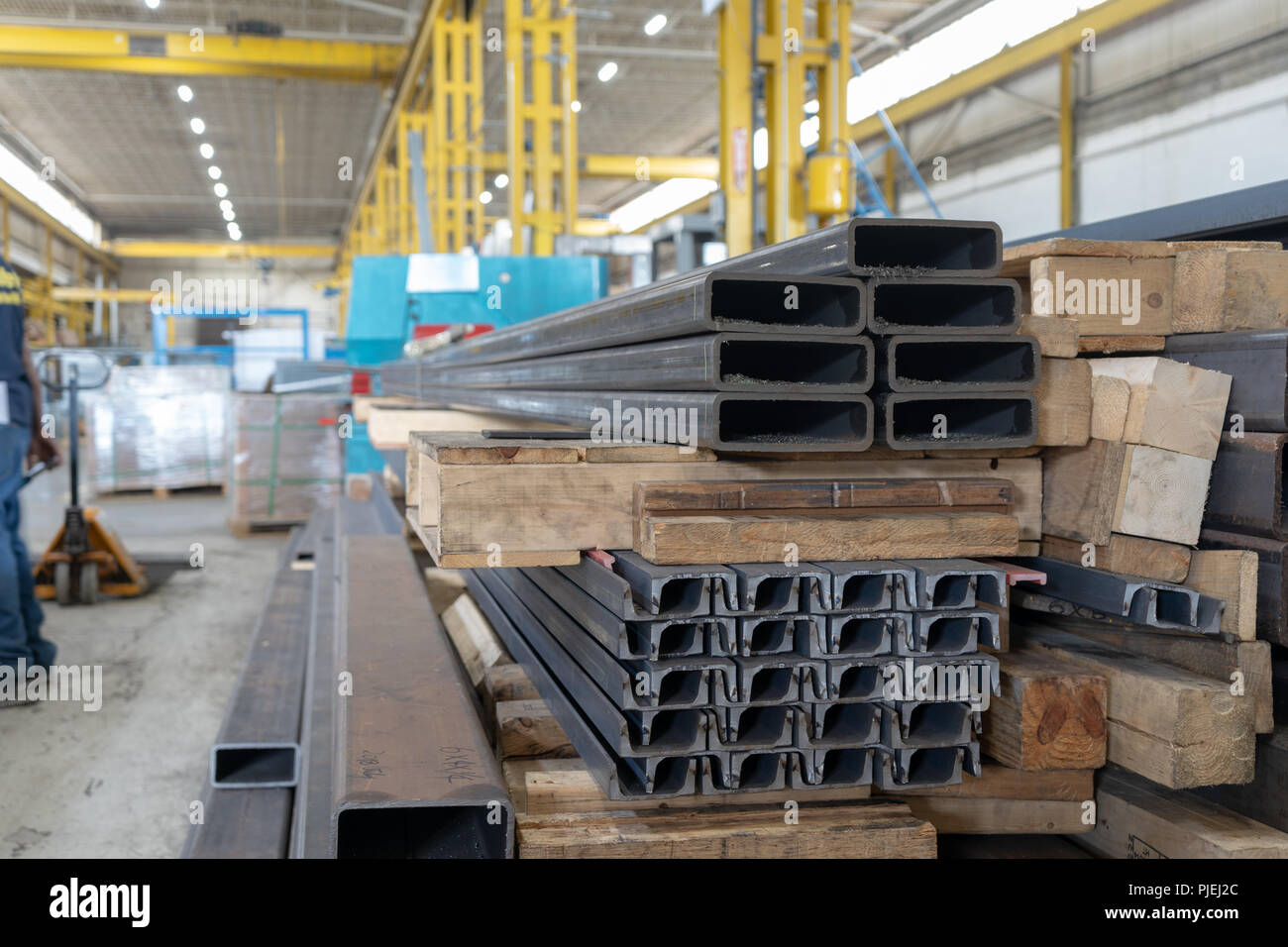 Steel tube and channel, stacked on skids at a Canadian plant with overhead cranes Stock Photo