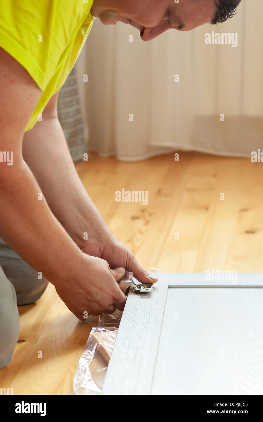 Assembling new, wooden furniture. Work of the master Stock Photo Alamy