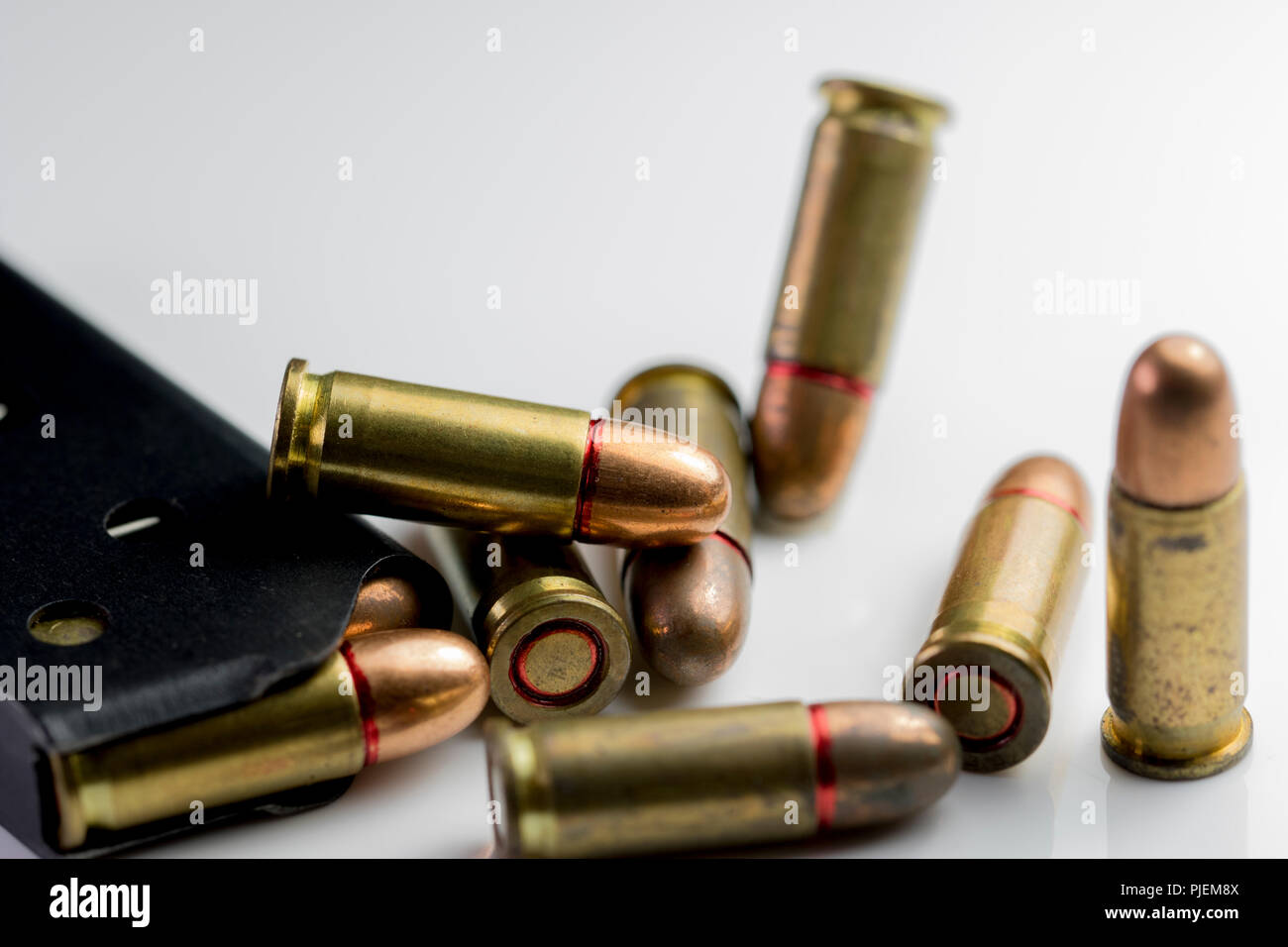Bullet shells and a gun clip close up. Macro of copper bullet hand gun rounds isolated on white