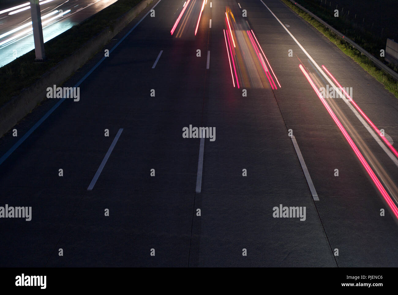 Traffic at Night - Three Red Taillights - Long Exposure Stock Photo