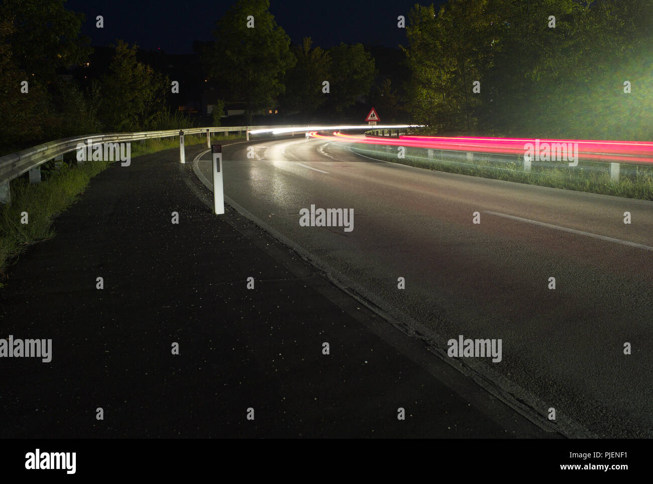 Traffic at Night - Red and White Light Trails around a Highway Corner - Long Exposure Stock Photo