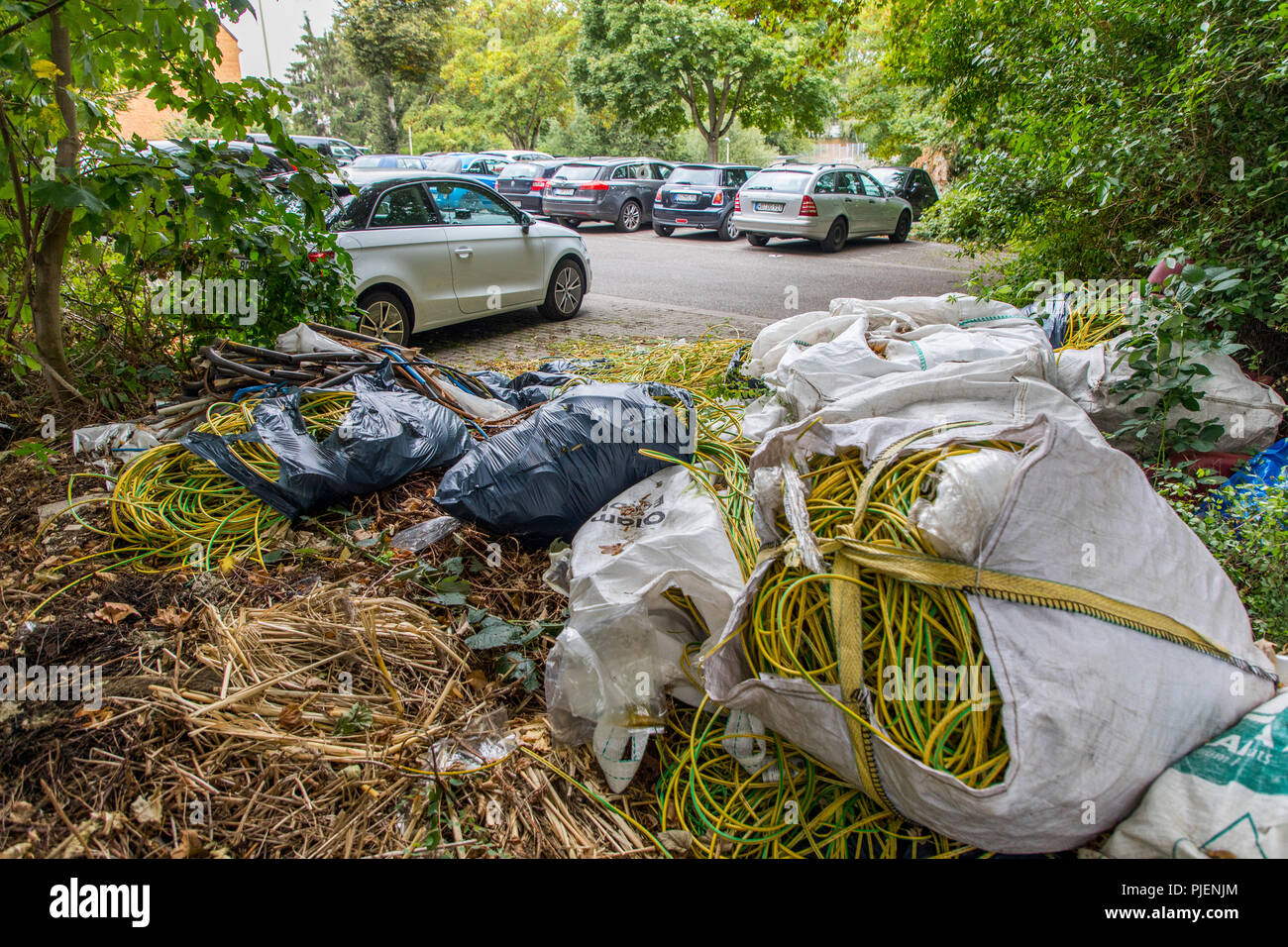 Wild garbage dump on a public parking lot, illegal disposal of