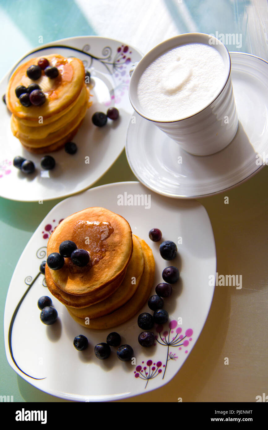 Desert With Coffee Sweet Pancakes Topped With Maple Syrup And Blueberries On The Stylish Plates White Cream Coffee Stock Photo Alamy