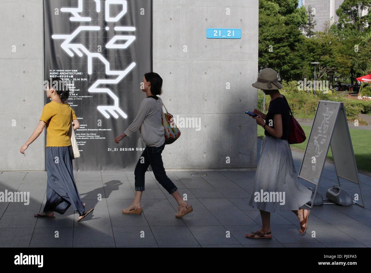 Visitors approaching an entrance to Tokyo Midtown's Tadao Ando-designed art museum 21 21 Design Sitein Roppongi. (August 2018) Stock Photo