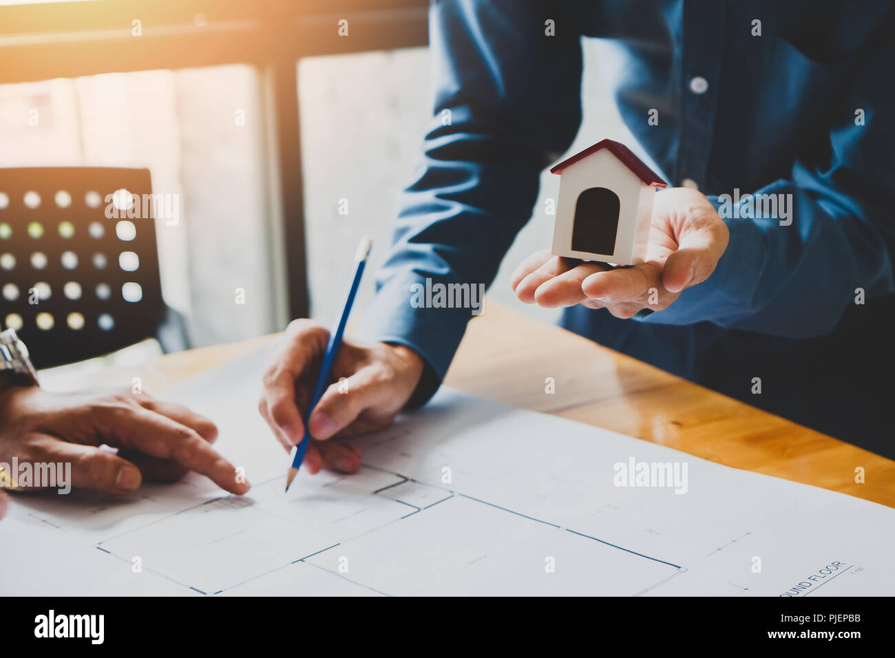 Architect or engineer using pen working on blueprint, architectural concept Stock Photo
