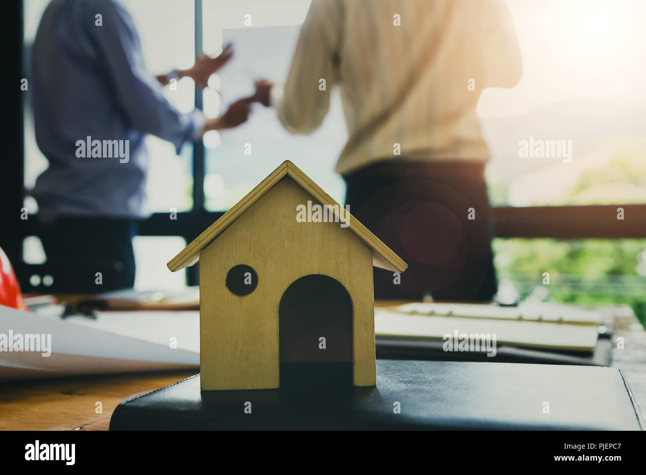A architects house model with plan and blueprints Stock Photo