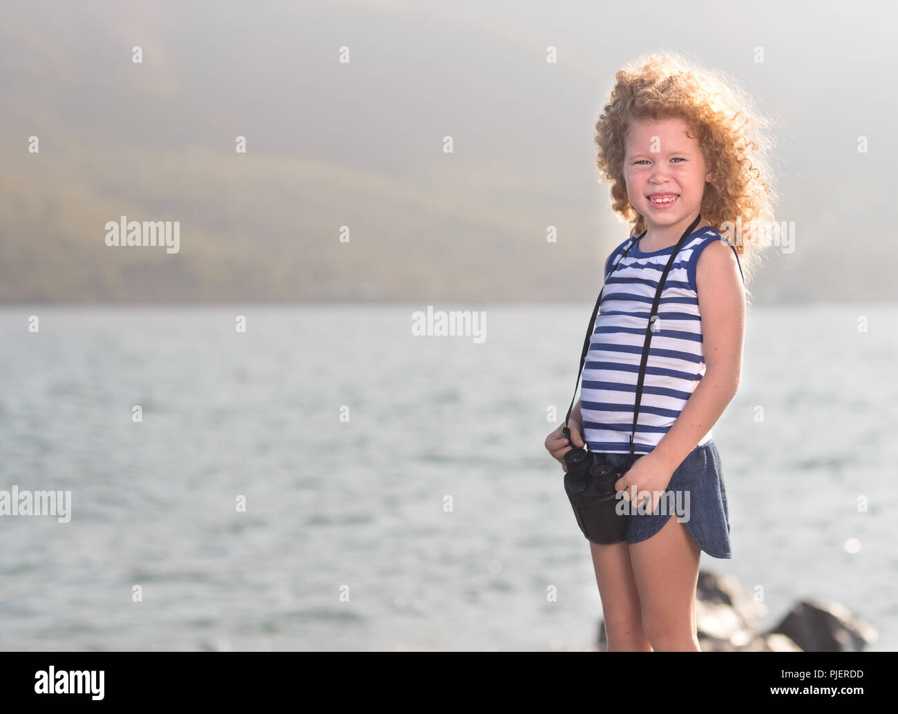 Beautiful girl sitting on rock hi-res stock photography and images - Alamy