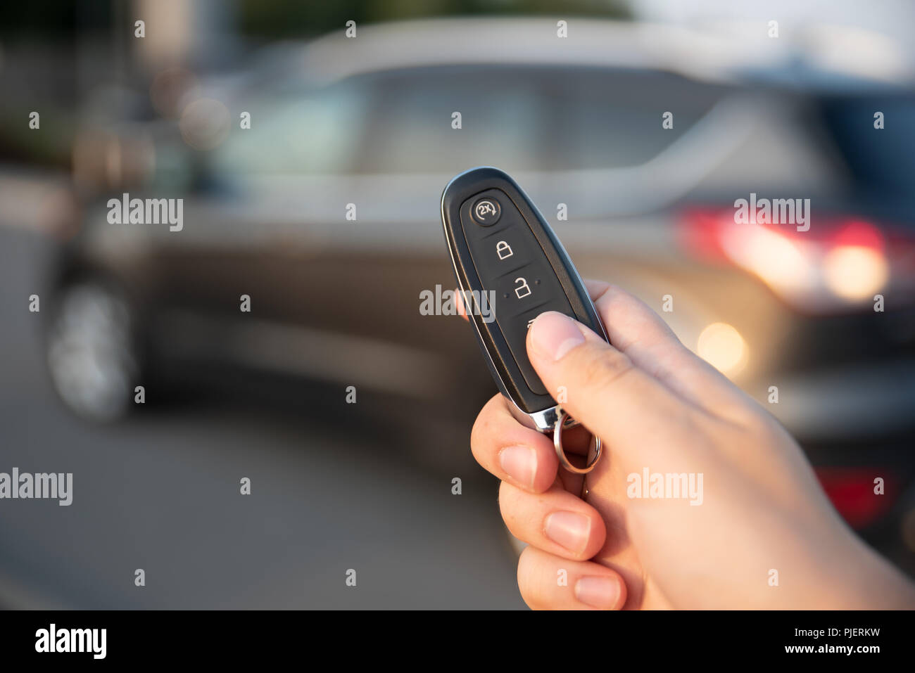 Man opening car with the control remote key. Keyless car system remote control Stock Photo