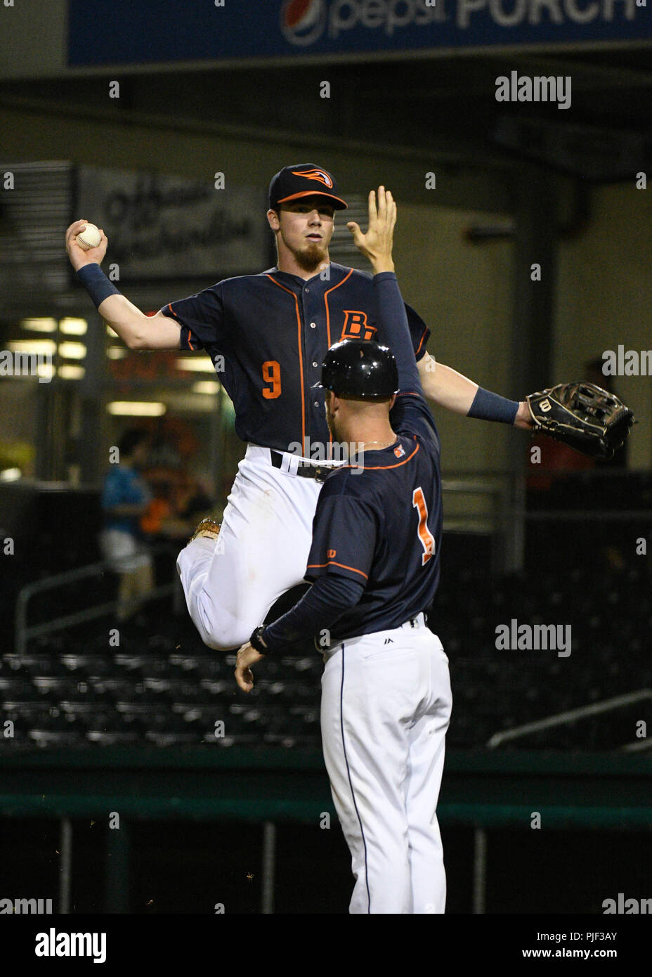 September 6, 2018; Bowling Green KY, USA Bowling Green Hot Rods left fielder Carl Chester (9) gives Bowling Green Hot Rods manager Craig Albernaz (1) a high five during a Mid West League series between the Lansing Lugnuts and the Bowling Green Hot Rods in Bowling Green, KY st Bowling Green Ballpark. Hot Rods sweep Lugnuts and advance t round two. (Mandatory Photo Credit: Steve Roberts/CSM) Stock Photo