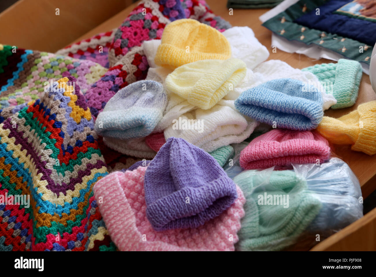 General views of Knitted babies hats, clothing and blankets in an old peoples home in Bognor Regis, West Sussex, UK. Stock Photo