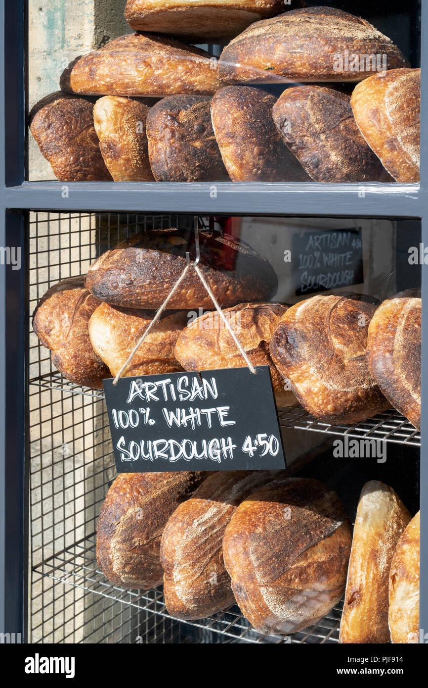 Sourdough bread for sale in a shop window. Burford, Cotswols, Oxfordshire, England Stock Photo