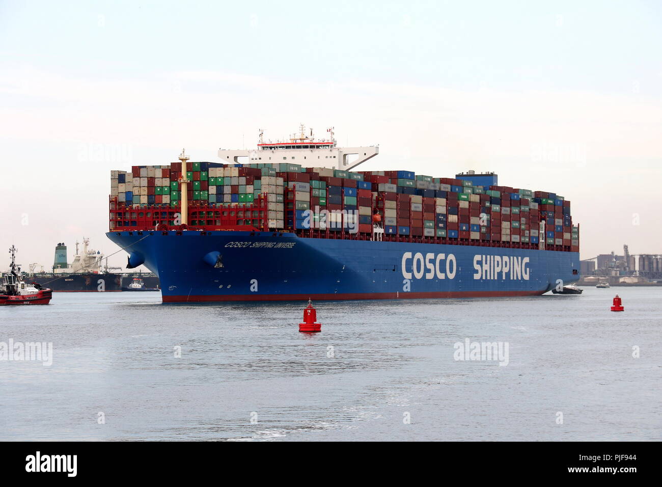 The large container ship COSCO Shipping Universe leaves the port of Rotterdam on 27 July 2018. Stock Photo