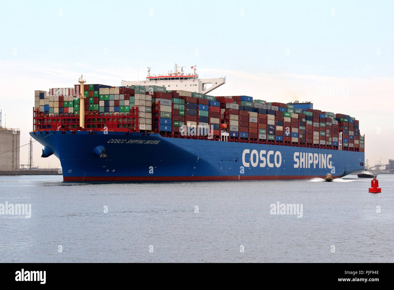 The large container ship COSCO Shipping Universe leaves the port of Rotterdam on 27 July 2018. Stock Photo