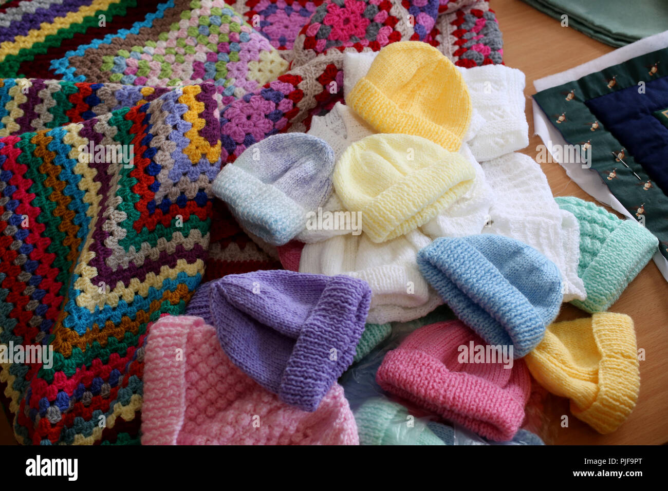 General views of Knitted babies hats, clothing and blankets in an old peoples home in Bognor Regis, West Sussex, UK. Stock Photo