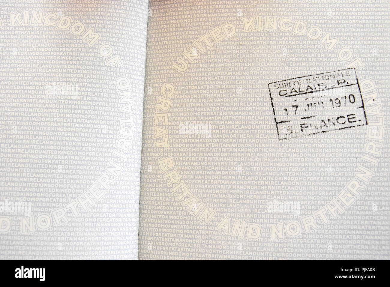 British United Kingdom UK passport. Original United Kingdom of Great Britain and Northern Ireland passport stamped in Calais, France, Europe. EU Stock Photo