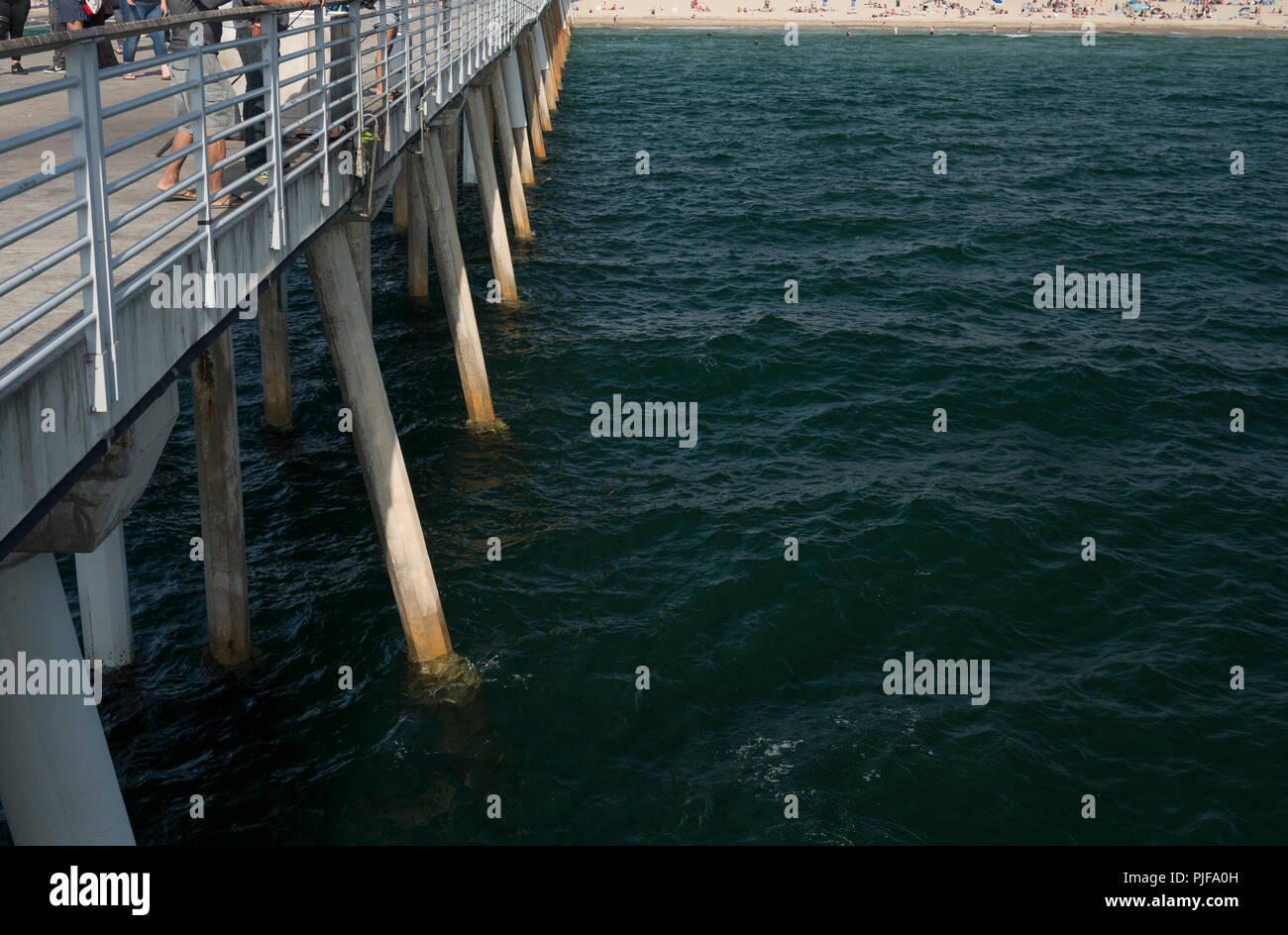 View of concrete pillars support a pier with view of the ocean Stock Photo